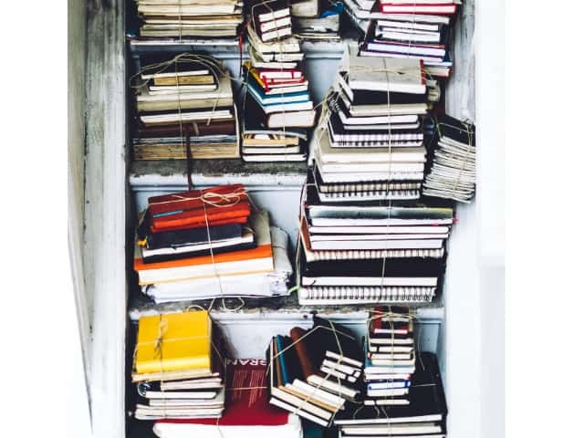 Stacks Of Journals Inside Of A Closet Photo